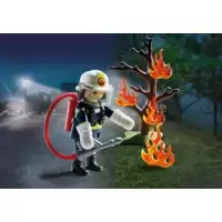 Fireman with burning tree