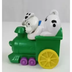 Dalmatian On green train engine with yellow wheels