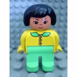Duplo Figure, Female, Light Green Legs, Yellow Blouse with Light Green Collar and Dark Pink Buttons, Black Hair, Grin