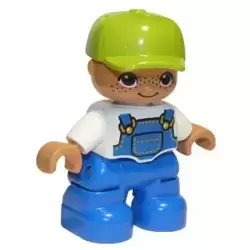Duplo Figure Lego Ville, Child Boy, Blue Legs, White Top with Blue Overalls, Lime Cap, Freckles, Oval Eyes