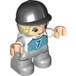 Duplo Figure Lego Ville, Child Boy, Light Bluish Gray Legs, Medium Azure Top with Number 7, Tan Hair, Black Riding Helmet (6323948)