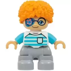 Duplo Figure Lego Ville, Child Boy, Light Bluish Gray Legs, White Shirt with Light Aqua and Medium Azure Stripes, Dark Blue Glasses, Coral and Dark Azure Eye Patch, Orange Hair (6533350)