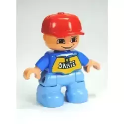 Duplo Figure Lego Ville, Child Boy, Medium Blue Legs, Blue Top with 'SKATE' Pattern, Red Cap (6233829)