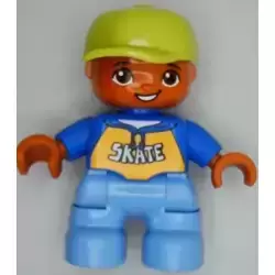 Duplo Figure Lego Ville, Child Boy, Medium Blue Legs, Blue Top with 'SKATE' Text Pattern, Lime Cap, Oval Eyes