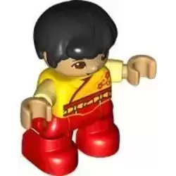 Duplo Figure Lego Ville, Child Boy, Red Legs, Yellow Robe, Bright Light Yellow Arms, Black Hair, Reddish Brown Eyes (6429723)